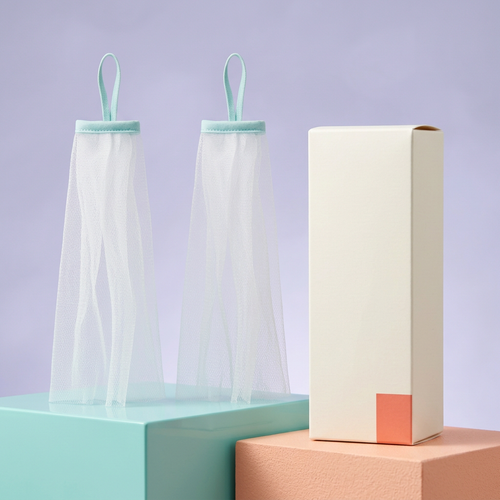 Two white foaming nets with aqua loops and ivory carton on colorful podiums