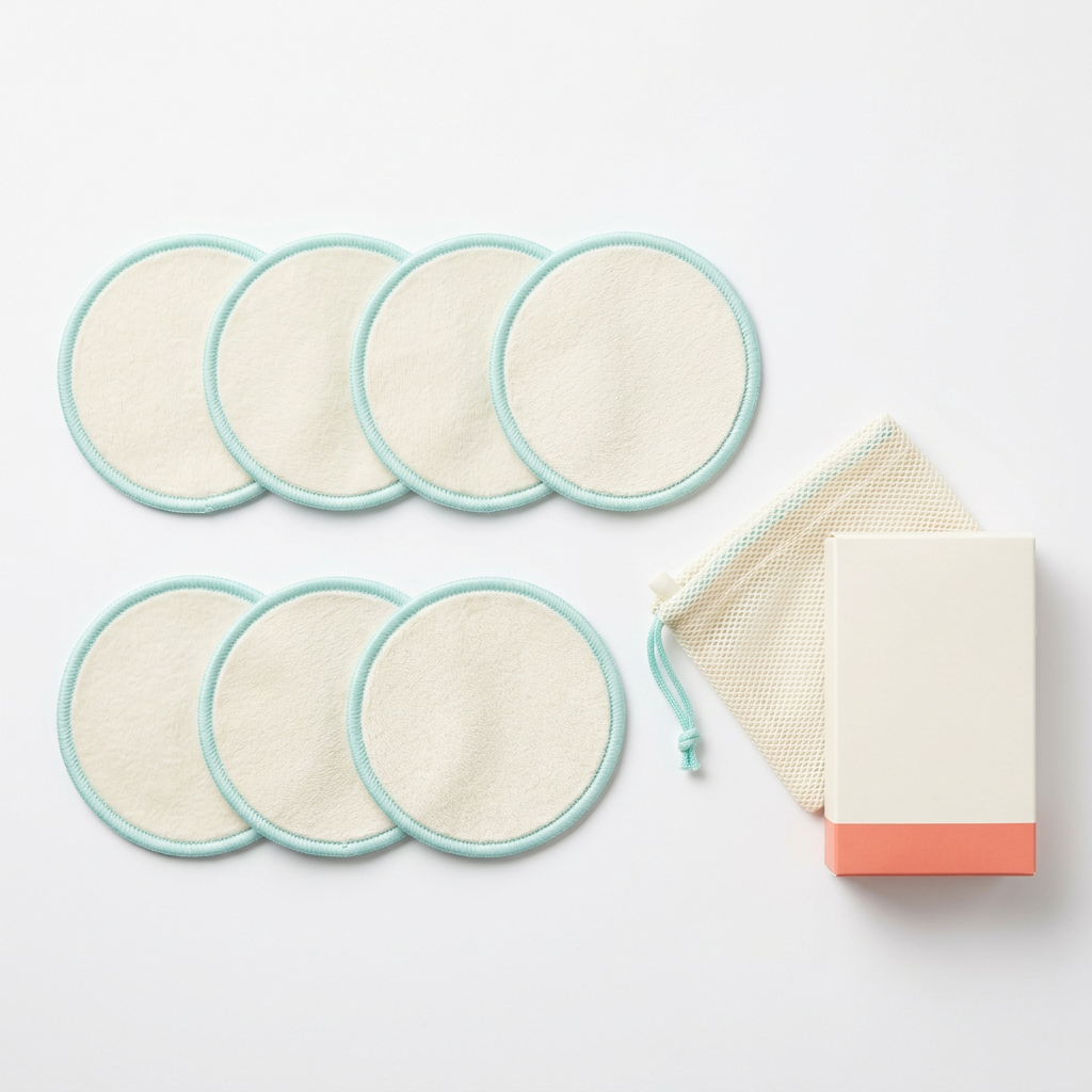 Seven ivory aqua-edged pads mesh bag and logo-free carton on white