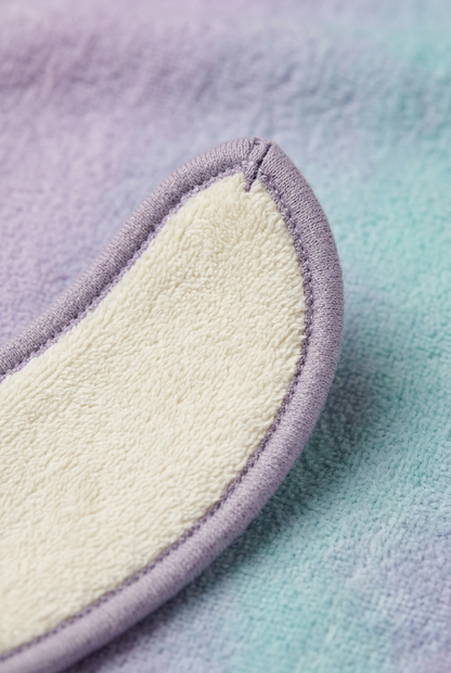 Close-up of rounded pad tip ivory textile and lavender binding