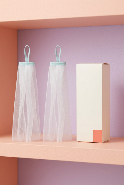 Two foaming nets with matching logo-free ivory packaging