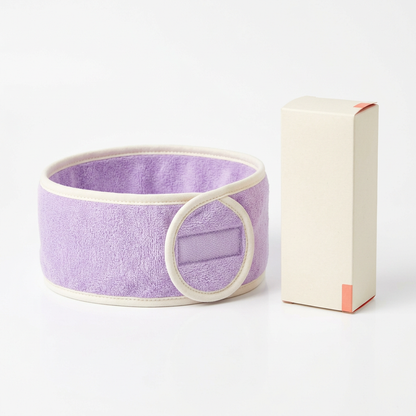 Lavender wrap skincare headband with ivory edging and logo-free ivory carton on white background