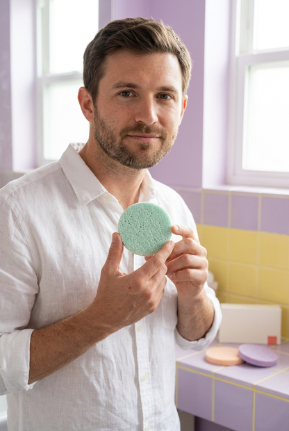 Adult male model holding a mint facial sponge