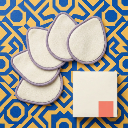 Five ivory teardrop pads and carton in a colorful flat lay
