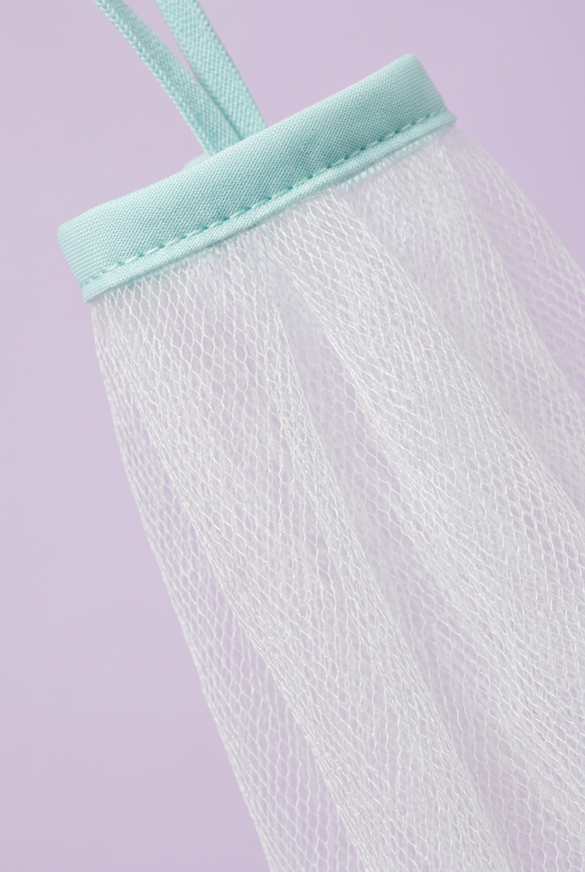 Close-up of white mesh and aqua binding