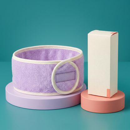 Lavender skincare headband and unbranded ivory carton on colorful display podiums